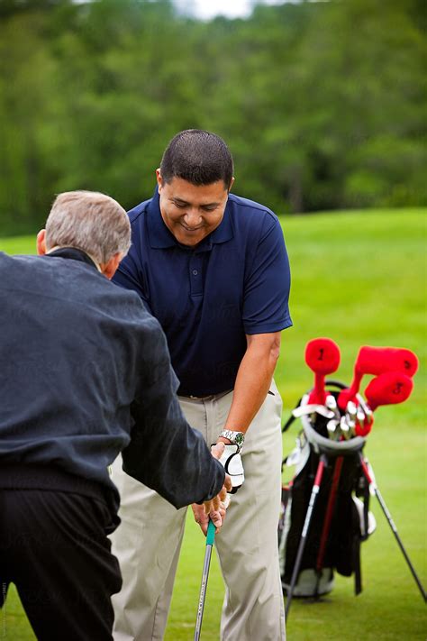 «Golf: Golf Instructor Showing The Proper Technique» del colaborador de Stocksy «Sean Locke ...