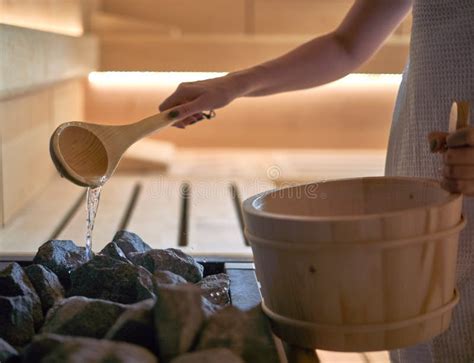 Woman Pouring Water into Hot Stone in Sauna Room Stock Image - Image of ...