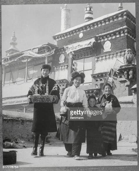 Wearing typical Tibetan garb, members of a family in Lhasa prepare to... News Photo - Getty Images