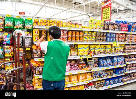 A young boy stocking shelves at a supermarket in Ensenada, Mexico Stock ...