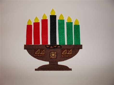 Kwanzaa candles in a kinara. I sing a song to the tune of "Twinkle ...