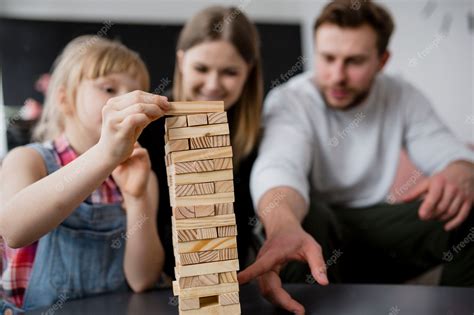 Free Photo | Blurred family playing jenga