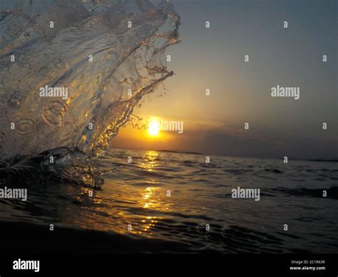 Silhouette of water splash at sunset, next to the sea Stock Photo - Alamy