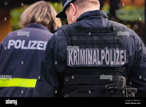 Dresden, Germany. 13th May, 2020. Two police officers from behind with ...