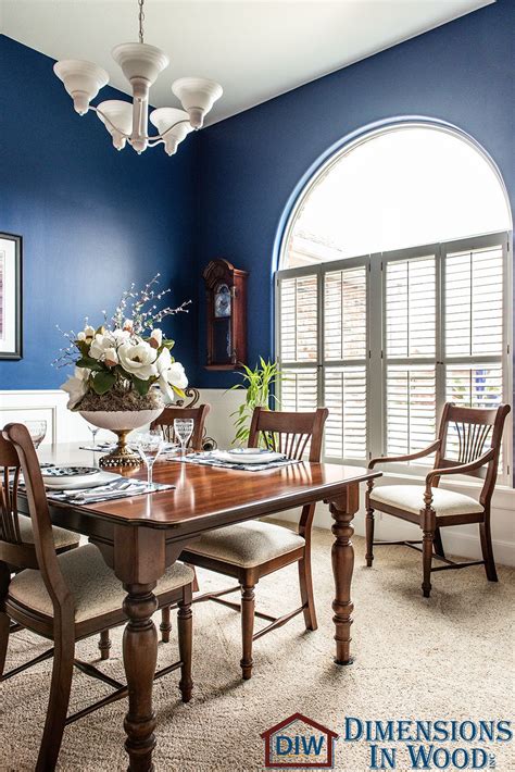 Custom White Wainscoting in Bold, Blue Formal Dining Room