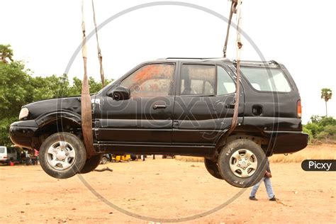 Image of Car Lifting Using Crane For a Movie Shooting-AI177603-Picxy