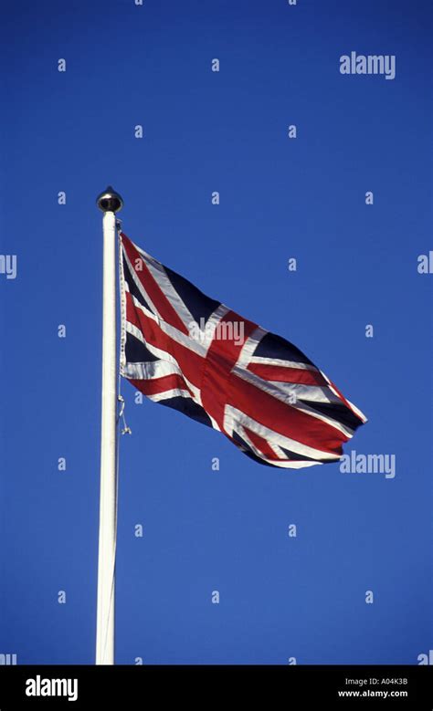 Union Jack on a white flagpole Stock Photo - Alamy