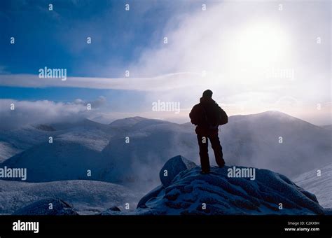 Winter walker at the summit of Slieve Bearnagh, Mourne Mountains ...