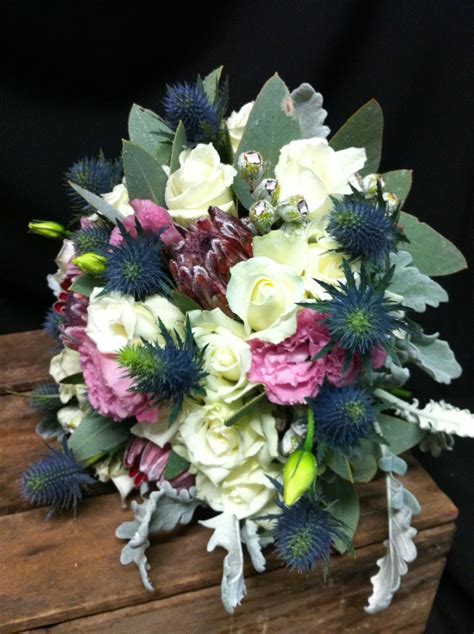 brides bouquet with pink ice protea, sea holly & lisianthus | Pink ice protea, Country style ...