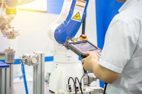 The Engineer Control the Robotic Arm for Manufacturing Process. Stock Photo - Image of industry ...