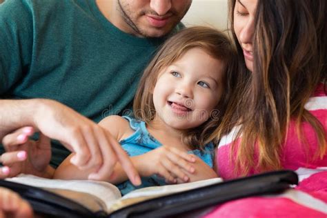 Family Reading the Bible Together Stock Photo - Image of christian, happy: 75975764