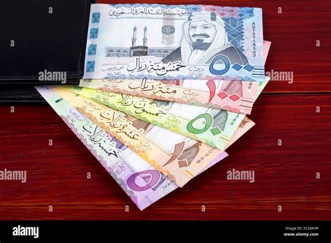 Saudi Riyal in the black wallet Stock Photo - Alamy