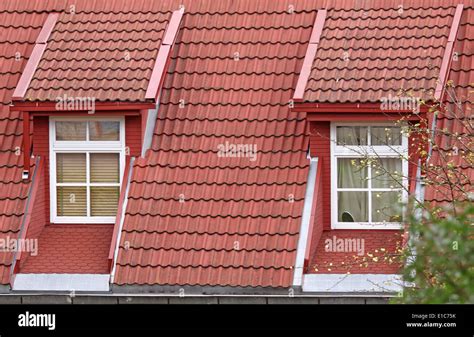 Two classic design roof windows with red tiles Stock Photo - Alamy