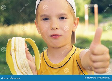 Healthy Little Boy Eating Banana. Happy Kid Enjoy Eating Fresh Fruit and Showing Thumbs Up ...