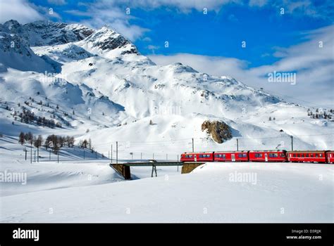 Mountain train at Lago Bianco Bernina Pass in Winter, Grisons ...