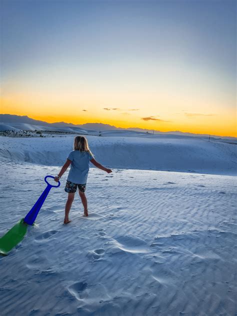 Pulling sled at White Sands National Park at sunset | Raising Hikers