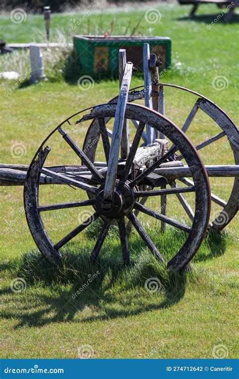 Old Wooden Cart Wheels on a Green Grass Field in the Countryside. Stock Photo - Image of wood ...