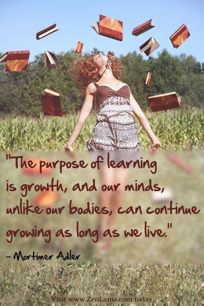 a woman is walking through the grass with books flying in the air