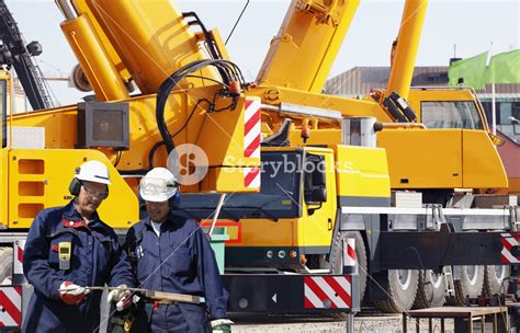 large mobile cranes with two building workers Royalty-Free Stock Image ...