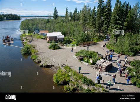 Tourists on Riverboat Discovery tour walk about Indian village along ...