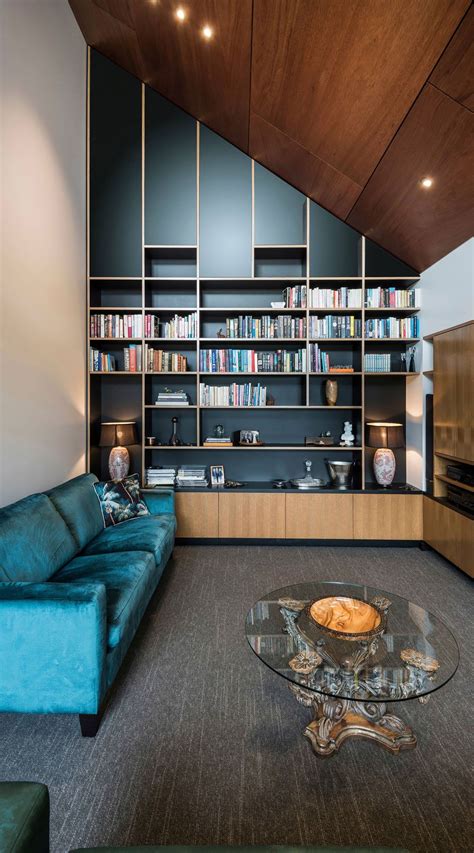 Contemporary Living Room With Blue Velvet Sofa And Black Accent Wall ...