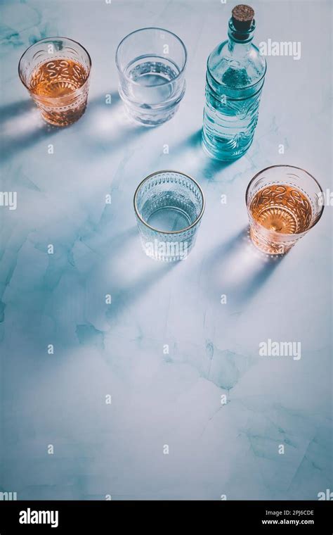 Water in vintage glasses with bottle Stock Photo - Alamy