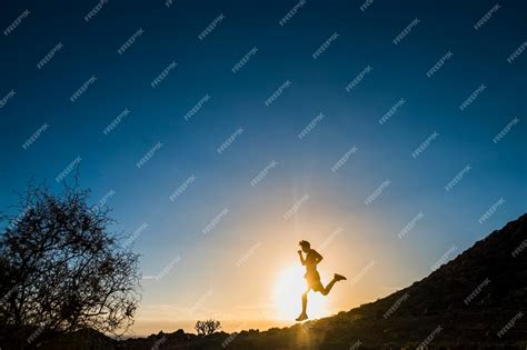 Premium Photo | Teenager running in mountains at the sunset - runner ...