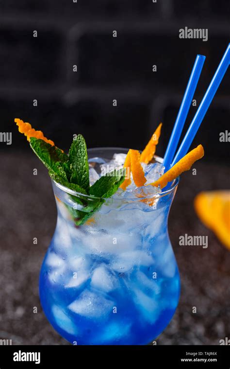 Blue cocktail drink with ice and orange Stock Photo - Alamy