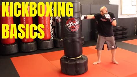 a man standing next to a punching bag on top of a red mat with the words kickboxing basics