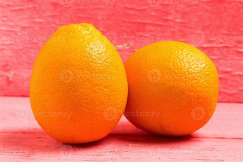 Orange fruit navel on pink wood 12600333 Stock Photo at Vecteezy