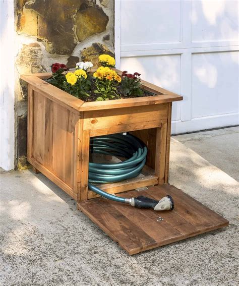 DIY Pallet Wood Hose Holder with Planter - diycandy.com