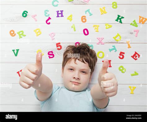 Little boy with rainbow alphabet letters showing thumbs up. School concept Stock Photo - Alamy