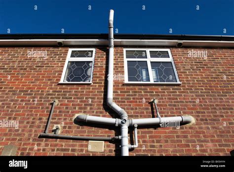 Drainpipe and water pipe system on a house Stock Photo - Alamy