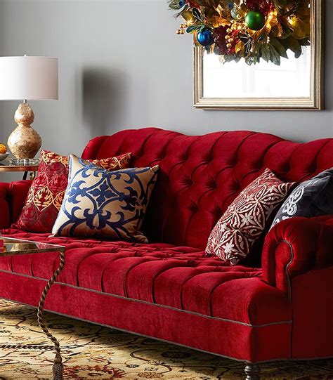 a living room with red couches and christmas decorations