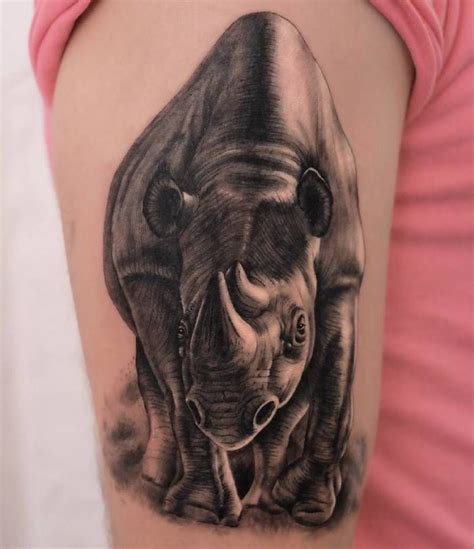 a rhinoceros tattoo on the right thigh