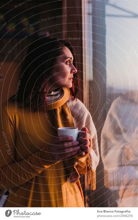 woman enjoys fresh coffee at sunset - a Royalty Free Stock Photo from Photocase