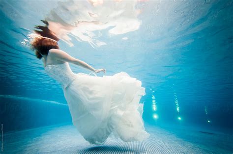 "Trash The Dress Underwater Bride Swimming At The Surface" by Stocksy Contributor "JP Danko ...