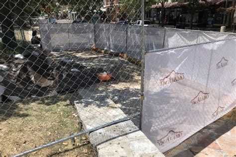 New Fence Wrap Allows Visitors to see Alamo Plaza Bollard Construction | The Alamo