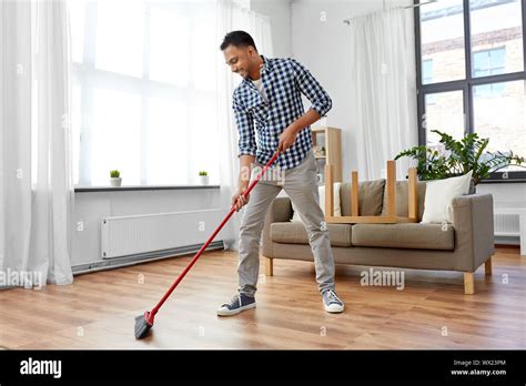 Man cleaning home broom hi-res stock photography and images - Alamy