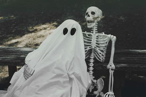 Free Photo | Ghost and skeleton hugging on bench