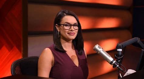 a woman sitting in front of a microphone