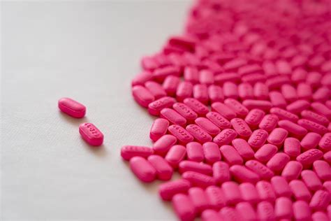 Pink Medication Pill on White Surface · Free Stock Photo