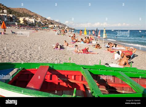 Tourists sunbathing, Letojanni Beach, Letojanni, Sicily, Italy Stock Photo - Alamy