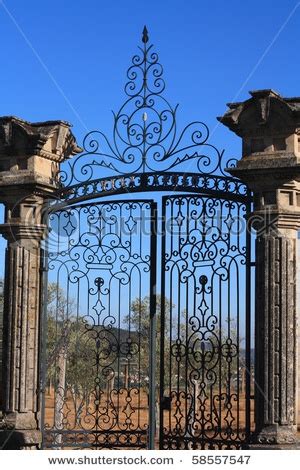 old wrought iron gates mounted on two granite columns | Iron gates, Wrought iron gates, Amazing ...