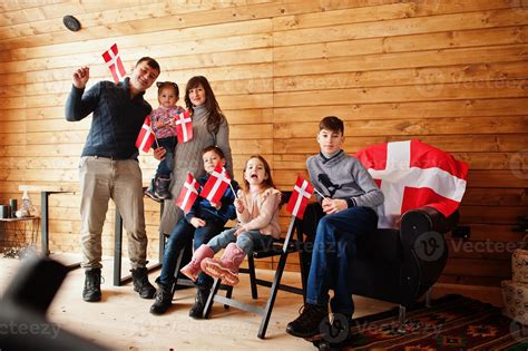 Family with Denmark flags inside wooden house. Travel to Scandinavian ...