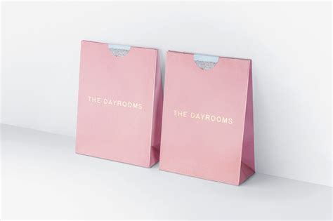 two pink shopping bags with the words the bathrooms printed on them are standing next to each other