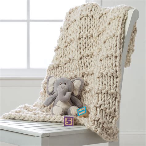 Create this cozy, bulky yarn lap throw with your basic knit and purl stitches. Get this f ...