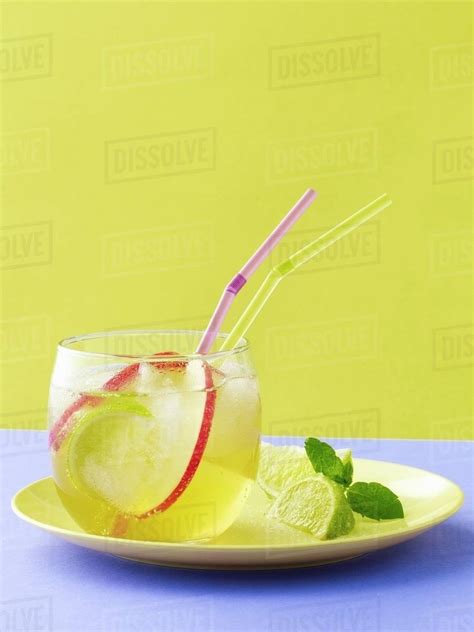 Pink lady apple, lime and ginger spritzer - Stock Photo - Dissolve
