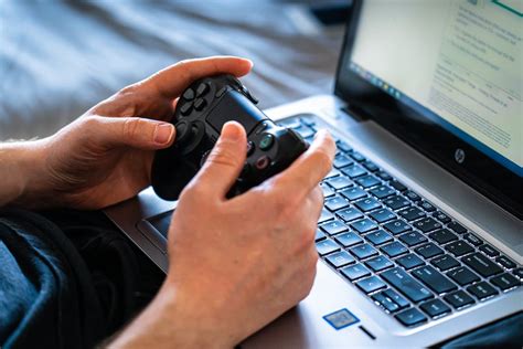 Person Holding Black Game Controller · Free Stock Photo