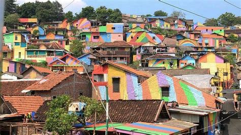 Ramshackle slum to 'rainbow village': Shanty town is transformed into top tourist spot thanks to ...